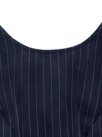 Close-up of a navy blue pinstripe suit jacket on a white background
