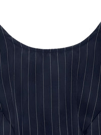 Close-up of a navy blue pinstripe suit jacket on a white background