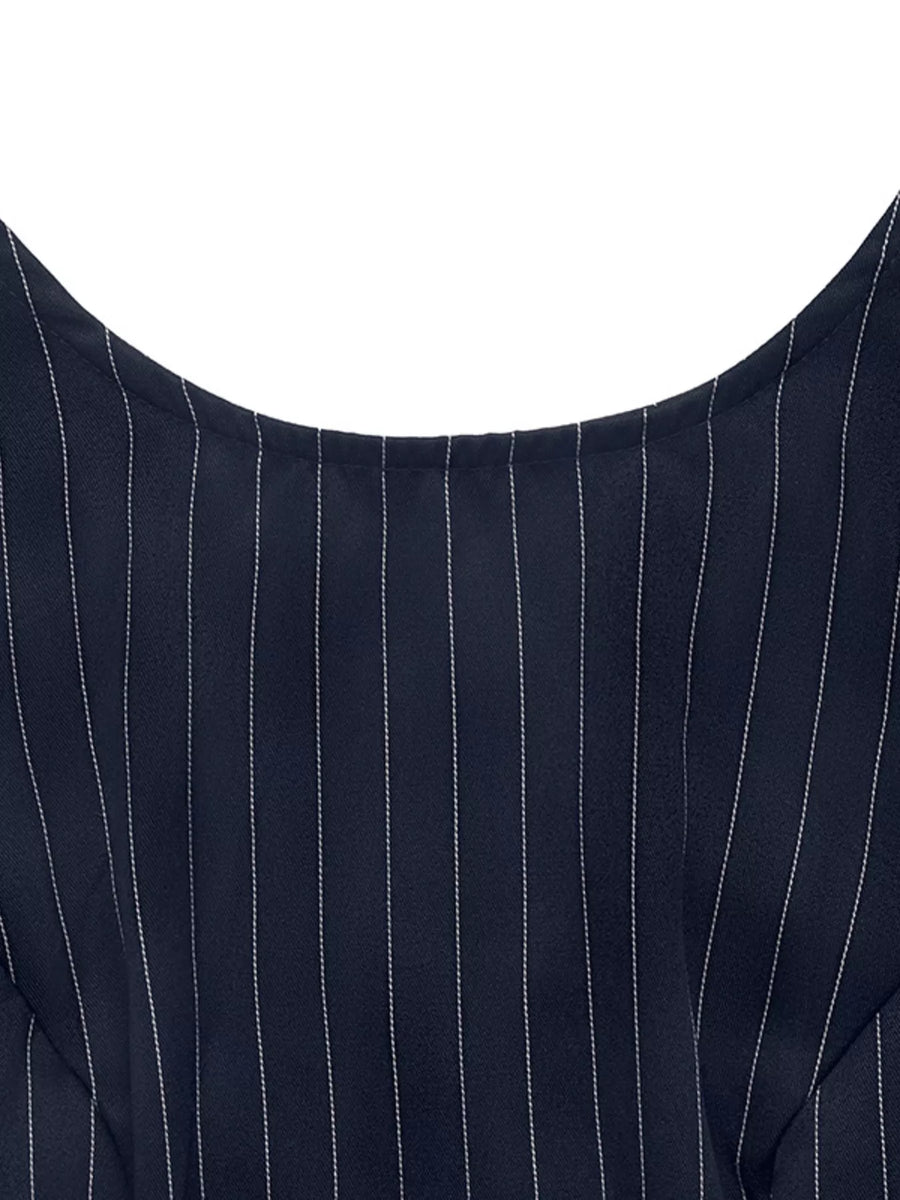 Close-up of a navy blue pinstripe suit jacket on a white background