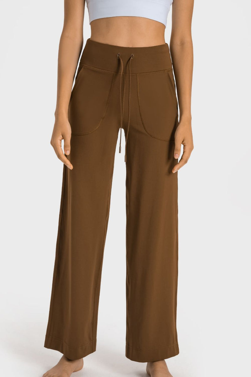 Brown wide-leg pants worn by a person on a white background