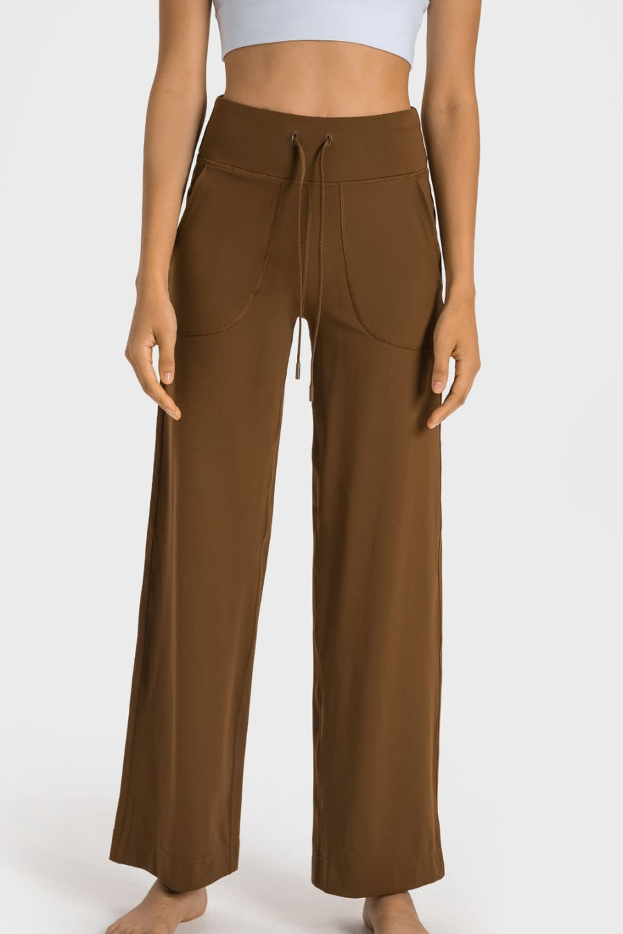 Brown wide-leg pants worn by a person on a white background