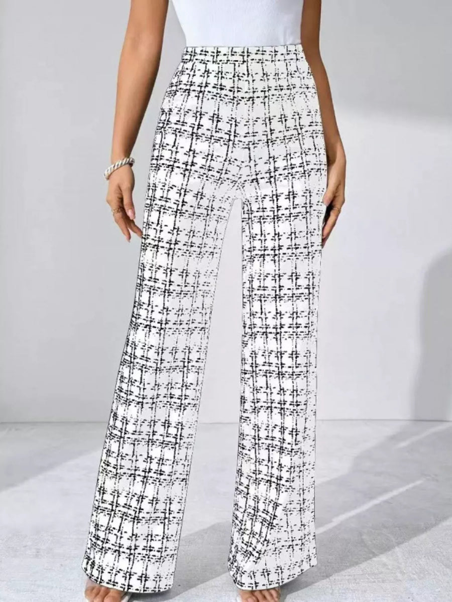 Plaid patterned pants worn by a person on a light gray background