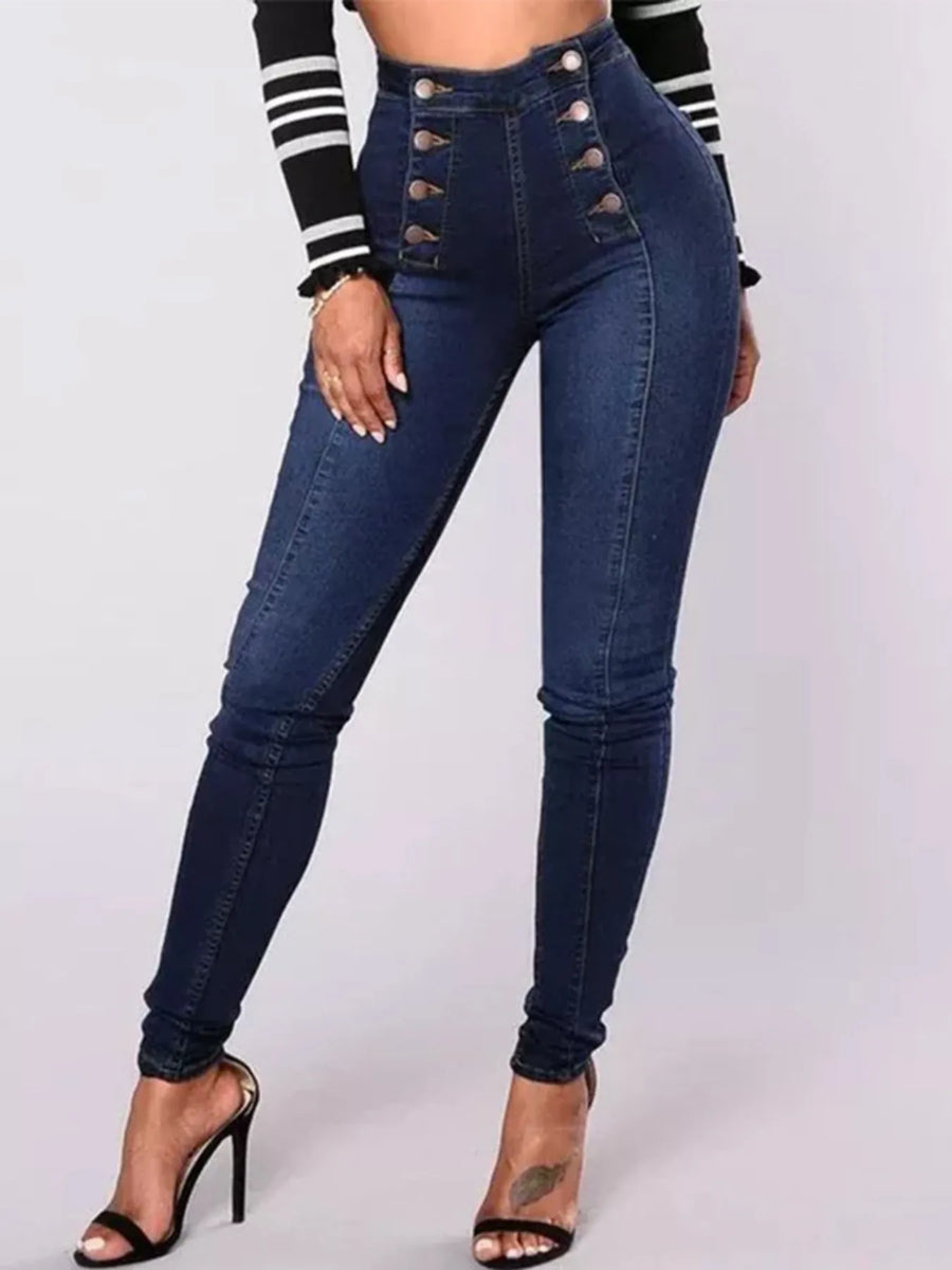 Blue jeans with button details worn by a person on a white background