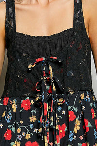 Black floral apron with colorful flowers on a plain background