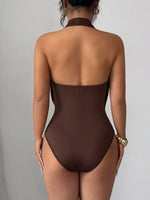 Brown swimsuit worn by a person on a gray background
