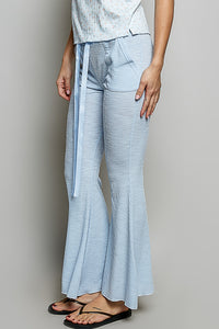 Light blue checkered pants worn by a person on a plain background