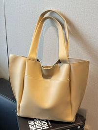 Yellow tote bag on a surface with a neutral background