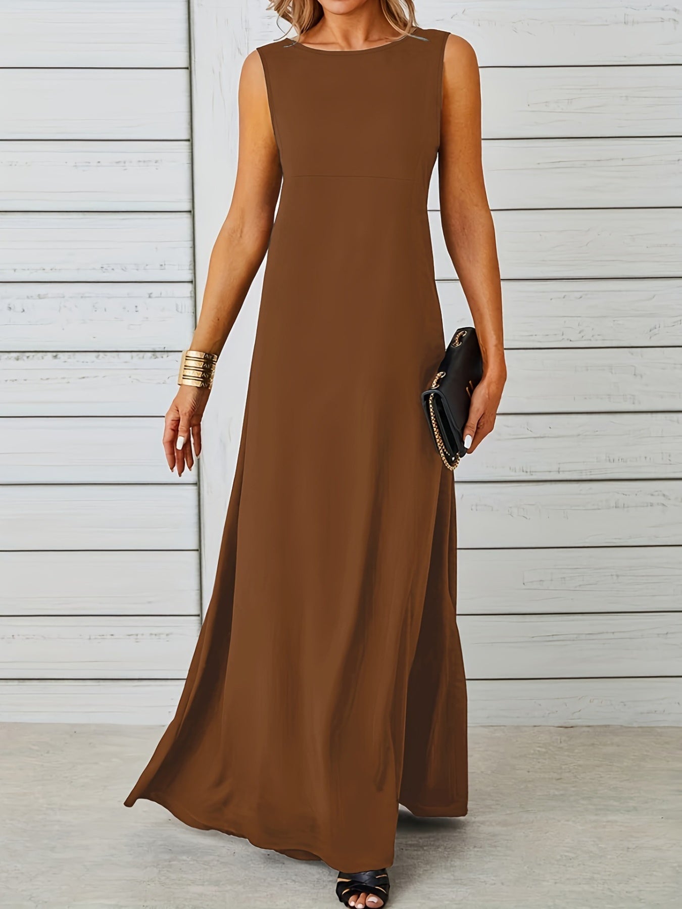 Woman wearing a brown sleeveless dress against a light wooden panel background