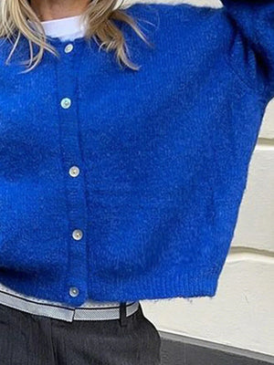 Blue cardigan with buttons on a neutral background