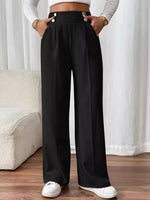 Person wearing black wide-leg pants with a white background