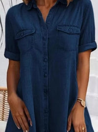 Navy blue button-up dress worn by a person with a blurred background