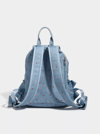 Light blue backpack with floral pattern on a light gray background