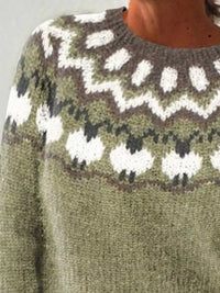 Close-up of a sweater with a pattern featuring sheep and zigzag designs.