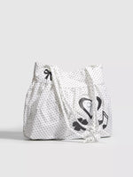 White tote bag with black patterns on a light gray background