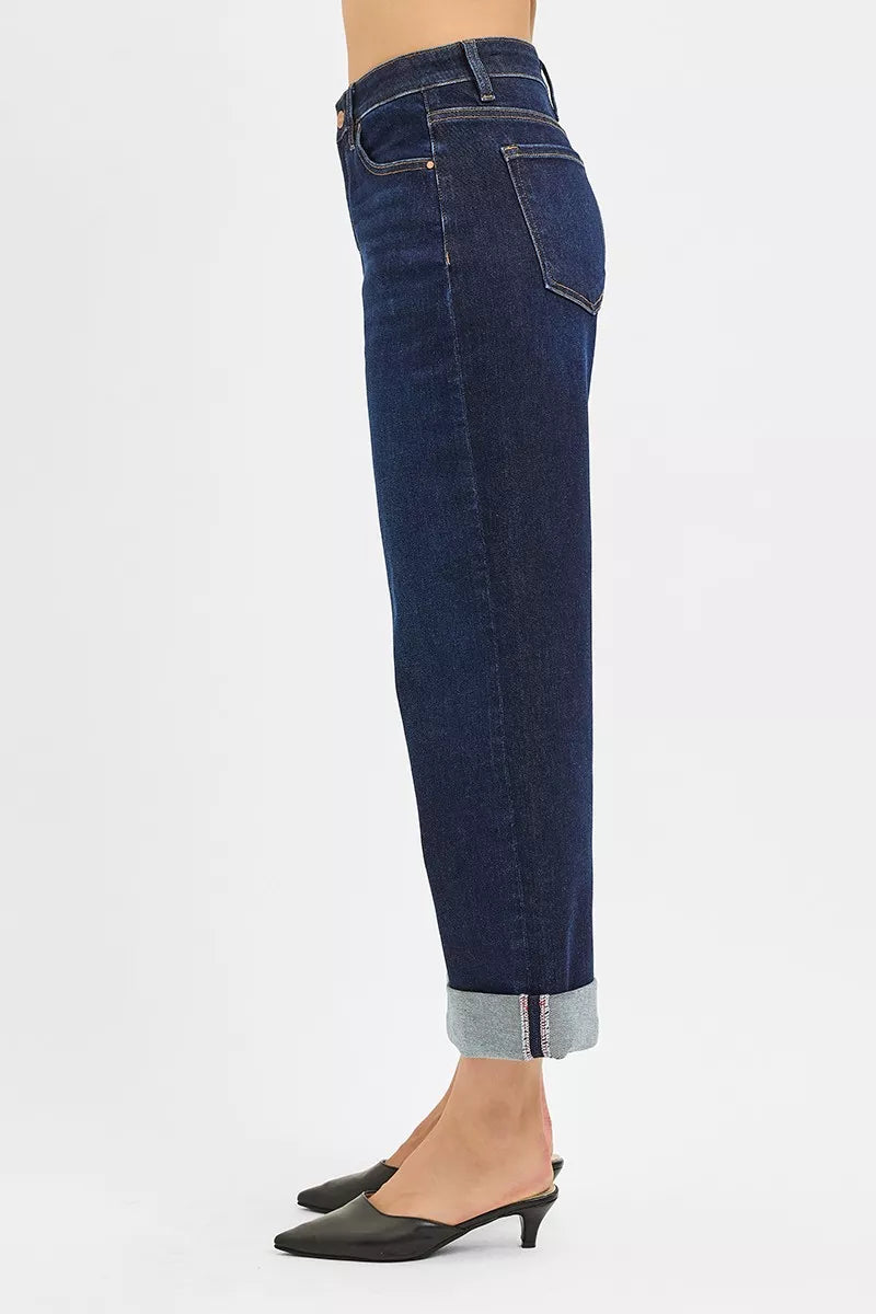 Blue jeans worn by a person on a white background