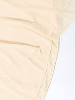 Close-up of beige fabric with a light background