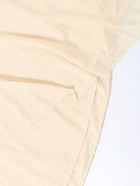 Close-up of beige fabric with a light background