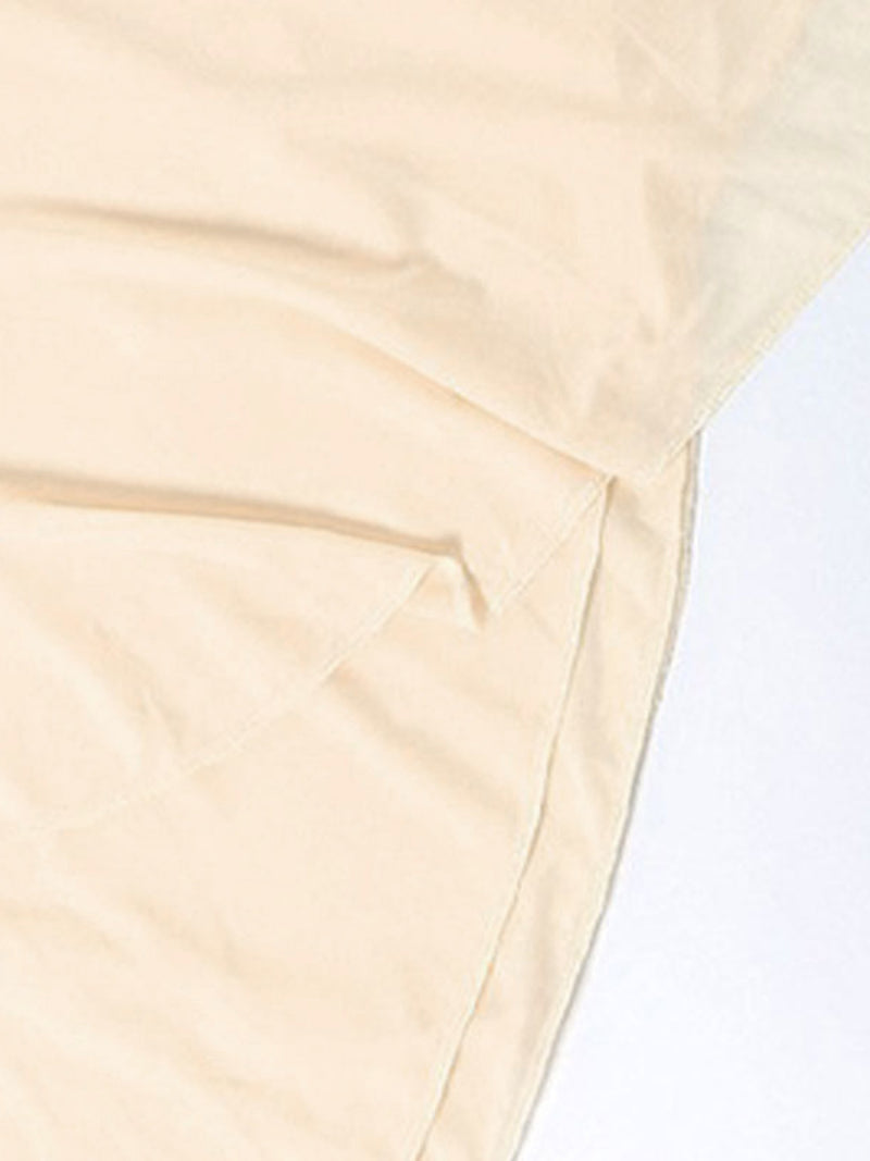 Close-up of beige fabric with a light background