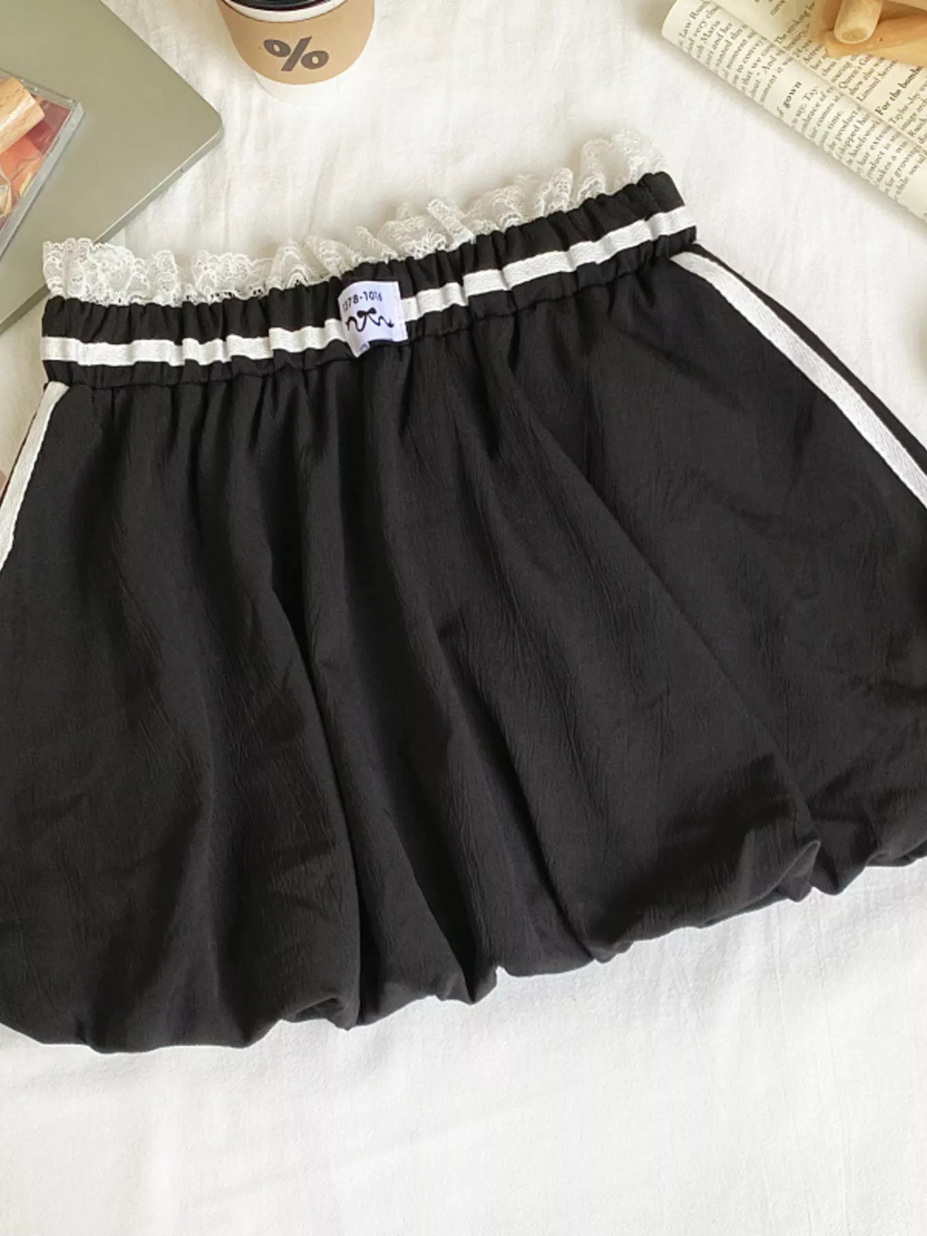 Black skirt with lace trim on a white surface