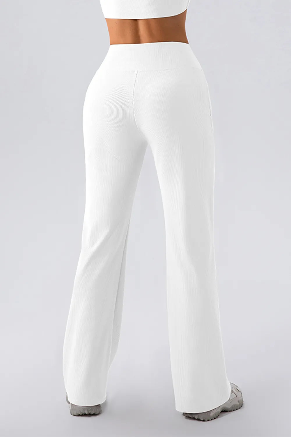 White wide-leg pants worn by a person on a light gray background