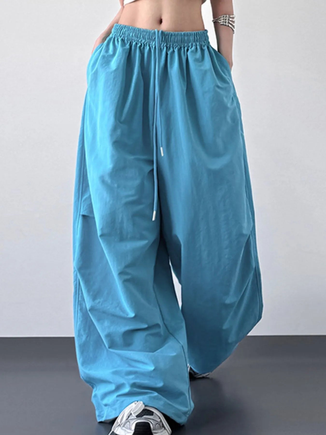 Blue wide-leg pants worn by a person on a plain background