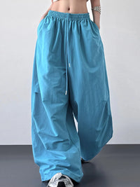 Blue wide-leg pants worn by a person on a plain background