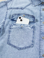 White phone in a blue denim pocket