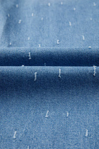 Close-up of blue denim fabric with white specks