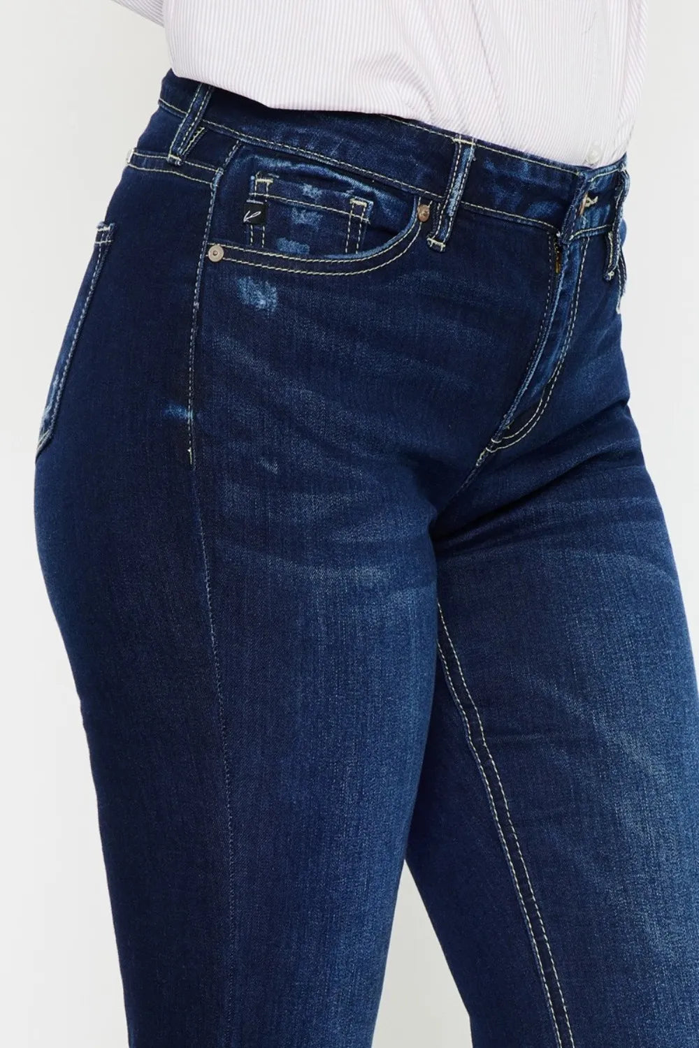 Blue jeans worn by a person on a white background