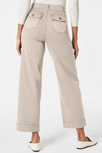 Beige pants worn by a person on a white background