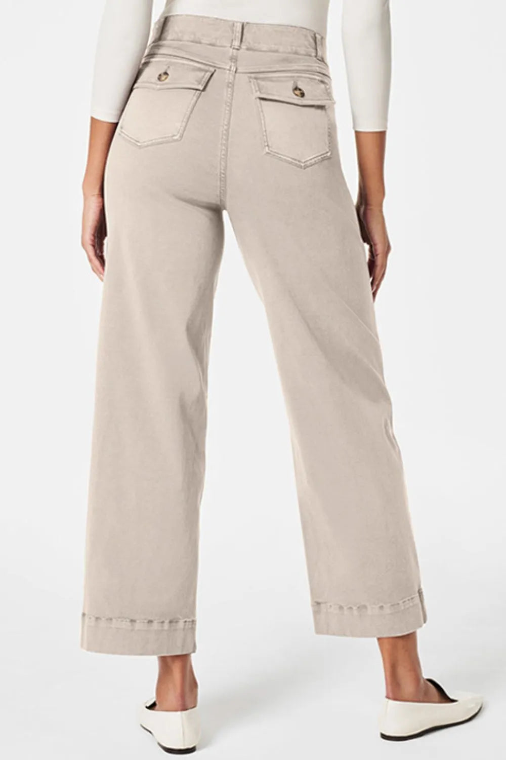 Beige pants worn by a person on a white background