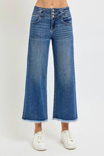 Blue jeans worn by a person on a white background