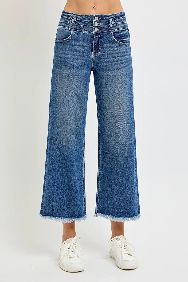 Blue jeans worn by a person on a white background