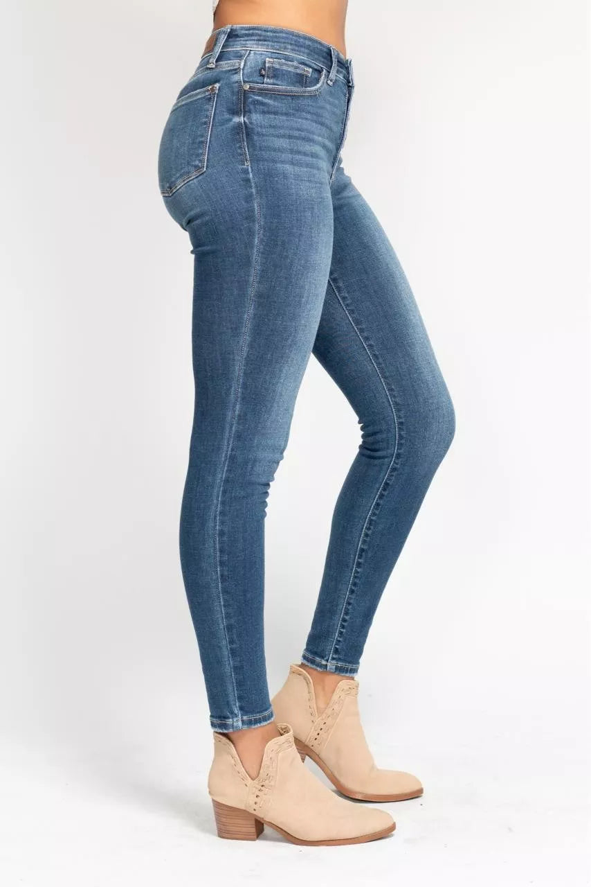 Blue jeans worn by a person on a white background