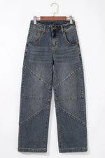 Blue jeans on a hanger against a white background