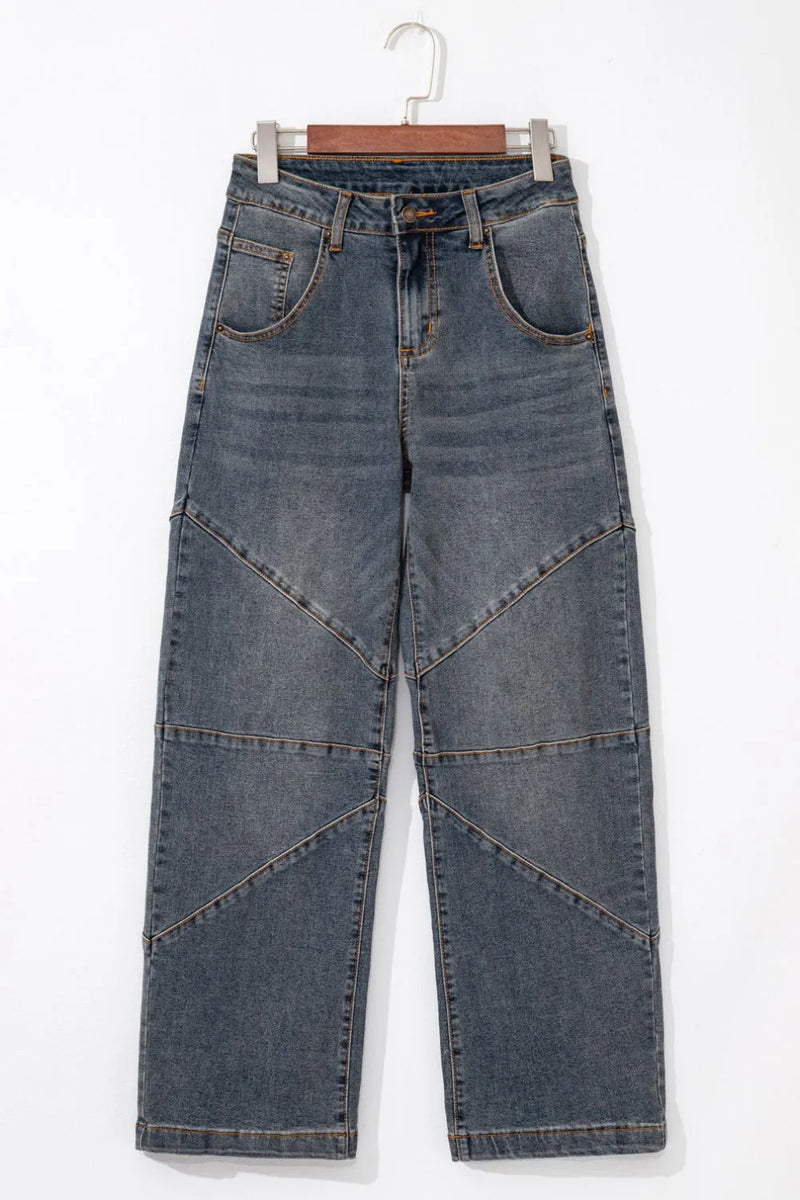 Blue jeans on a hanger against a white background