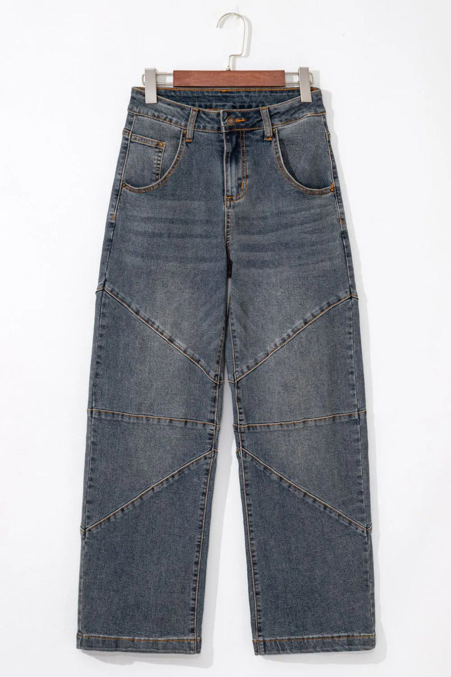Blue jeans on a hanger against a white background