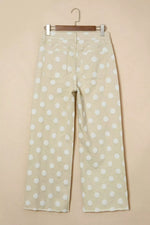 Polka dot pants hanging on a beige background
