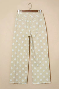 Polka dot pants hanging on a beige background