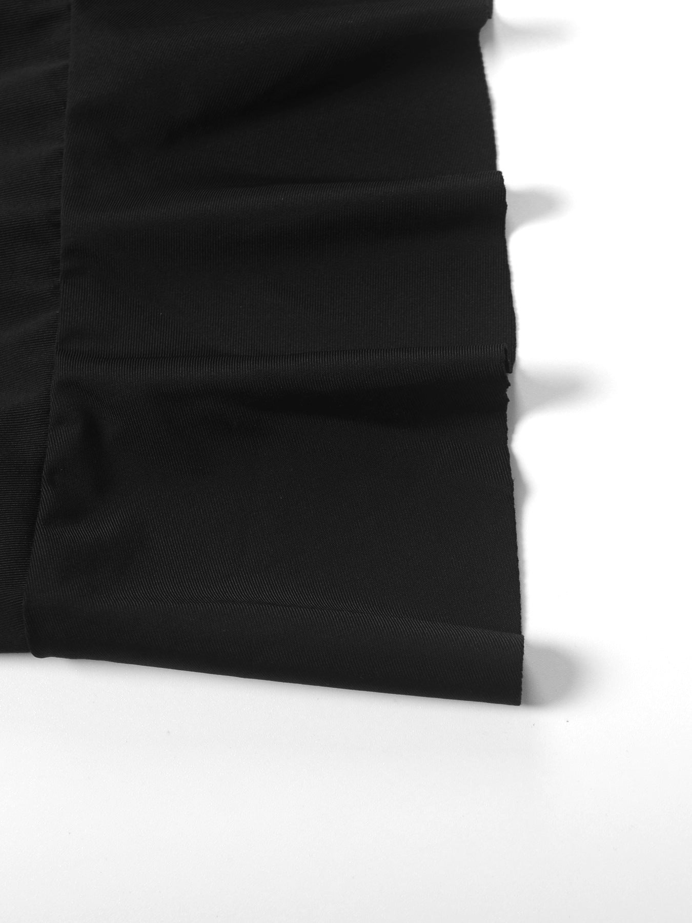 Close-up of a black fabric texture on a white background