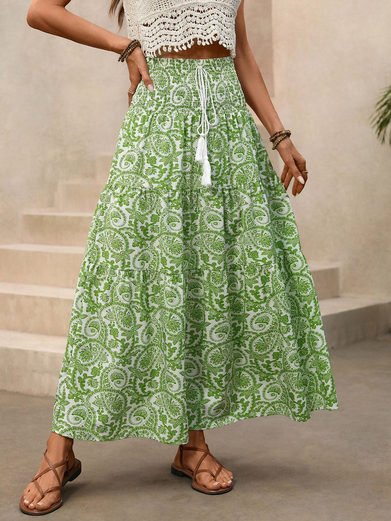 Person wearing a green patterned skirt with a neutral background