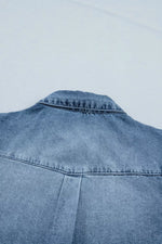 Blue denim jacket on a light gray background