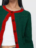Green and red cardigan with brown buttons on a white background