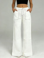 White wide-leg pants worn by a person on a gray background