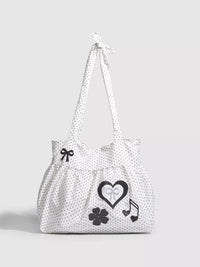 White tote bag with black patterns on a light gray background