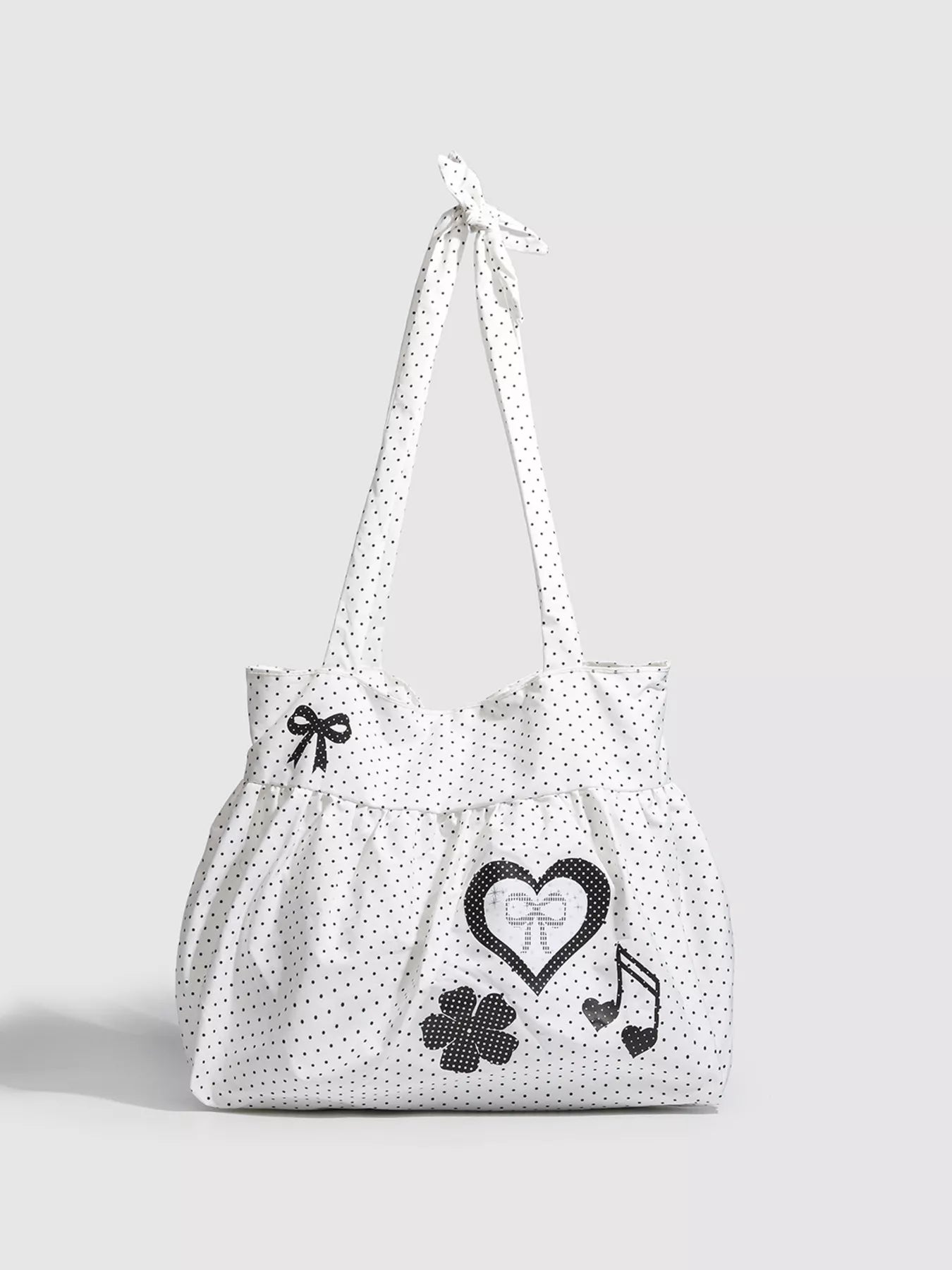 White tote bag with black patterns on a light gray background