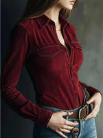 Person wearing a red velvet shirt with a neutral background