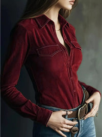 Person wearing a red velvet shirt with a neutral background