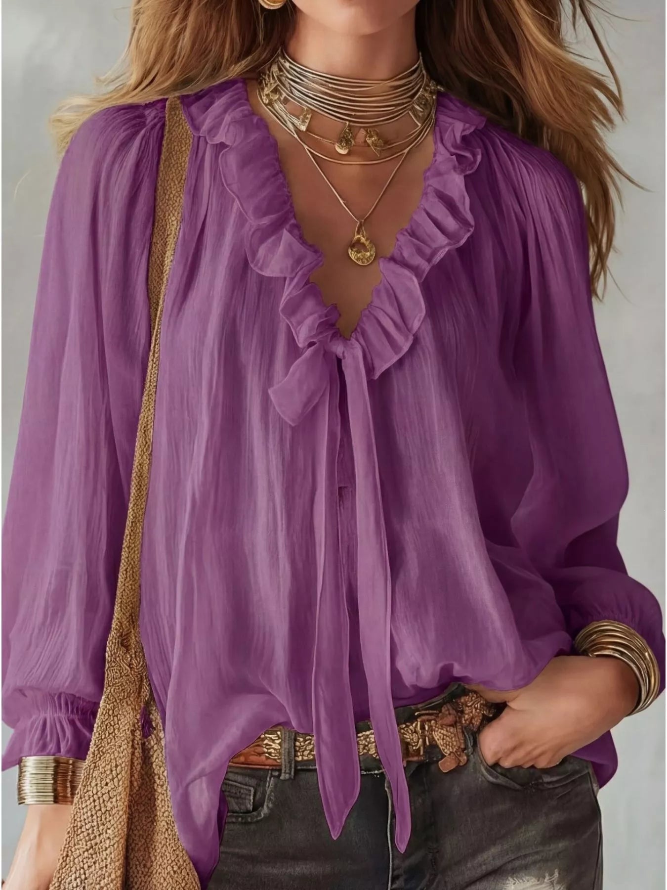 Purple blouse with ruffled details worn by a person, accessorized with necklaces and a belt.
