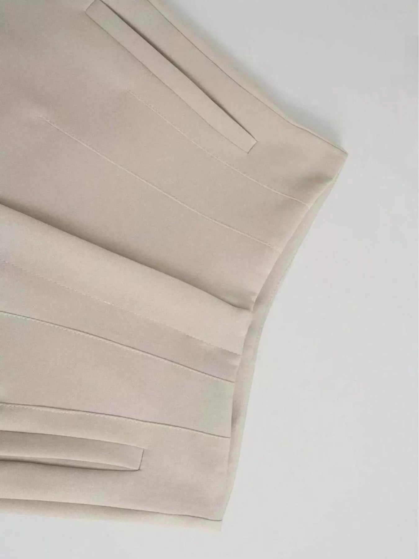 Beige bed sheets on a white background